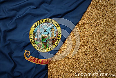 wheat grain on the waving colorful big flag of idaho state Stock Photo