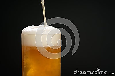 Wheat unfiltered beer poured into glass over dark background Stock Photo