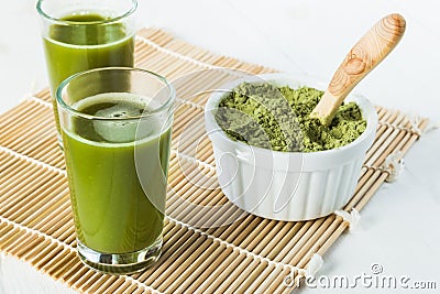 Wheatgrass juice shots in small glasses Stock Photo