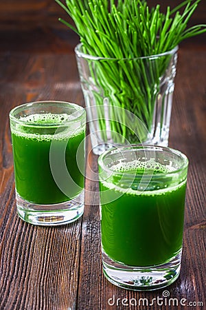 Wheatgrass shot. Juice from wheat grass. Trend of health. Stock Photo