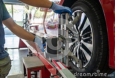 Wheel alignment of a vehicle in progress Stock Photo