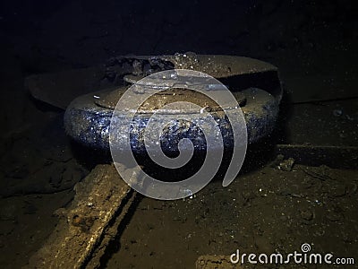 The wheel of a Japanese Mitsubushi Zero fighter in the cargo hold of a ship sunk at Truk Lagoon Stock Photo