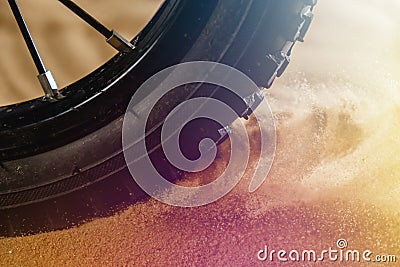 Wheel mountain bike bicycle detail in a sunny day and flying motion sand Stock Photo