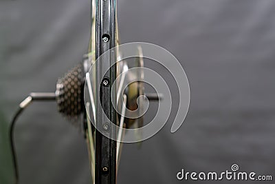 The wheel of a mountain electric bike in the workshop is a close-up on a black background. Repair of electric bicycles. Ecological Stock Photo