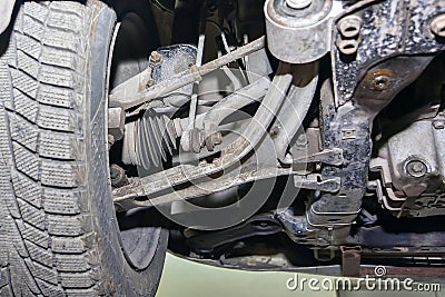 The wheel, suspension and chassis of a car standing on a car lift close-up Stock Photo