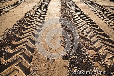 Wheel tracks in the sand go into the distance Stock Photo