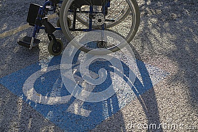 Wheelchair on disable parking reserved space lot,handicap respect Stock Photo