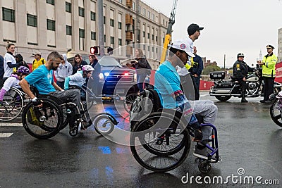 Wheelchair paraplegic athletes racing in street marathon Editorial Stock Photo