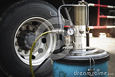 Wheeled Grease Filling Machine. Pressure Gauge Valve. Truck Wheels Maintenance. Stock Photo