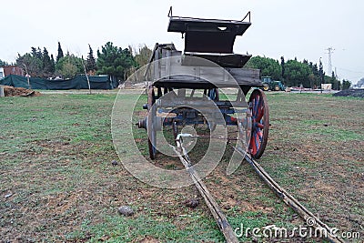 An old horse carriage on the grass Stock Photo