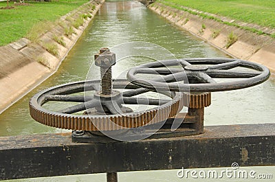 Wheels and cogs for floodgate controlling in canal Stock Photo