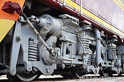 Wheels of a Russian modern locomotive, view from side. Transportation industry concept. Heavy wheels and mechanism under the elec Stock Photo