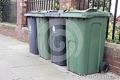 Wheely bins on pavement awaiting collection with North Tyneside Council crest and signage Editorial Stock Photo