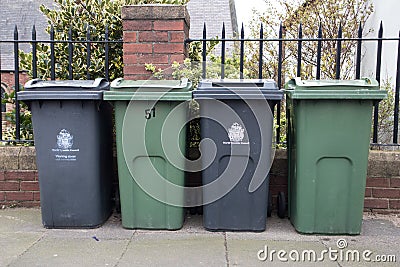 Wheely bins on pavement awaiting collection with North Tyneside Council crest and signage Editorial Stock Photo