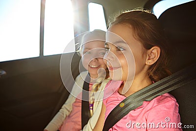 Where do you think were going to next. a two little girls traveling in a car. Stock Photo
