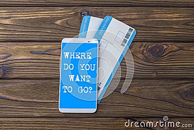 Where do you want to go? screen of the mobile phone, air tickets on airplane. Stock Photo