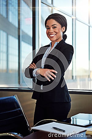 Where theres a will, theres a way. Portrait of a young female lawyer standing by her desk in the office. Stock Photo