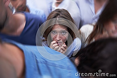 Wheres the escape. a fearful young woman feeling trapped by the crowd. Stock Photo