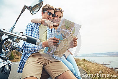 Wheres our next stop. a couple using a map while out on a road trip. Stock Photo