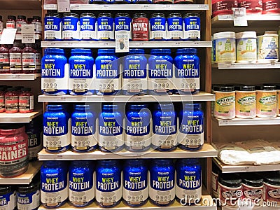 Whey protein jars on store shelf Editorial Stock Photo