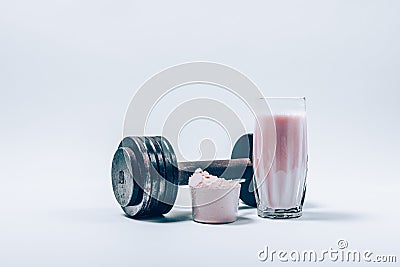 Whey protein shake in a glass next to scoop of powder Stock Photo