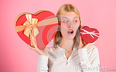 Which one she prefer. Girl decide which gift she like more. Big surprise and small gift. Make choice. Romantic gift for Stock Photo