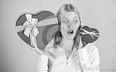 Which one she prefer. Girl decide which gift she like more. Big surprise and small gift. Make choice. Romantic gift for Stock Photo