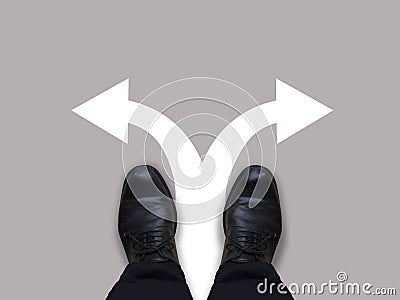 Which way - direction choices and decisions for businessman in black shoes with left and right directional arrows - business conce Stock Photo