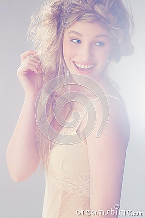 Whimsical beauty...A pretty model smiling and looking side ways. Stock Photo