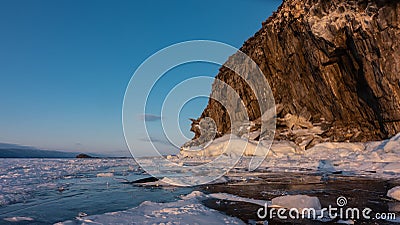 A whimsical rock, devoid of vegetation, against the backdrop of a blue sky. Stock Photo