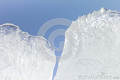 Whimsical surface ice closeup on blue sky background. Stock Photo