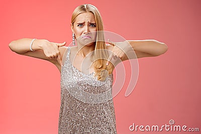 Whining complaining upset depressed blond woman in silver dress crying boyfriend broke-up prom night standing unhappy Stock Photo