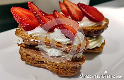 Whipped cream cake decorated withfresh strawberries wedges Stock Photo