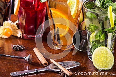 Whiskey-cola cocktail, mojito-cocktail, orange cocktail, strawberry cocktail in glass glasses with straws. Bar accessories: shaker Stock Photo