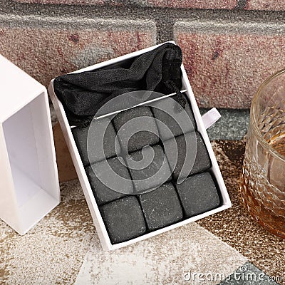 Whiskey cooler set gray soapstone stones close up. Concept shot, top view. Cooling cube whiskey stone concept. Gray whiskey stone Stock Photo