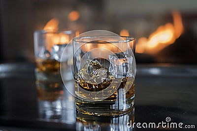 Whiskey on the rocks by the fire Stock Photo