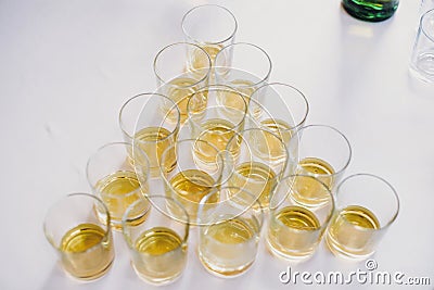 Whiskey row on table party at wedding reception. Whisky in glasses at alcohol bar. Christmas tree and New Year feast. Celebrations Stock Photo
