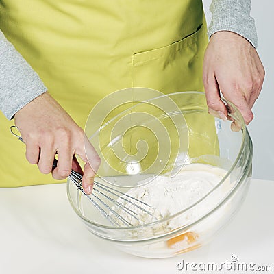 Whisking batter in kitchen Stock Photo