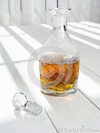 Whisky decanter standing on a wood table Stock Photo