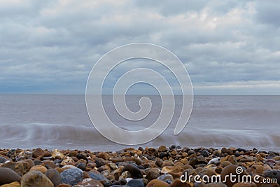 Whispy waves long exposure on Felixstowe beach Stock Photo