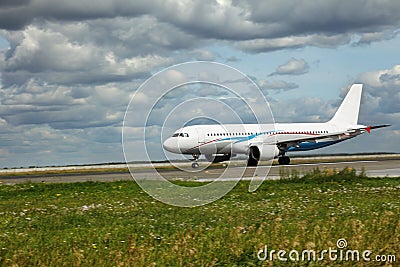 White airplane moves along Runway Stock Photo