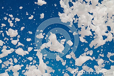 White airy foam on a blue sky background Stock Photo