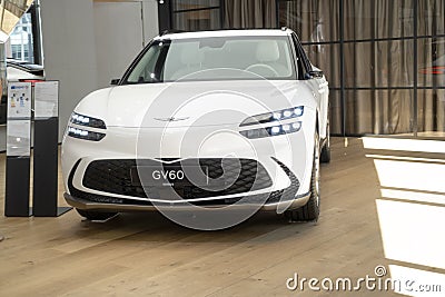 white all-electric Hyundai Genesis GV60 in Studio, popular korean Electric SUV vehicle in showroom, alternative energy development Editorial Stock Photo