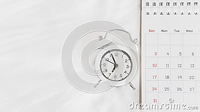 White analog alarm clock and calendar on white bed , travel schedule or work from home concept Stock Photo