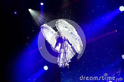 White Angel on Blue Background Spotlights, Aerial Performance, Gymnastic Artist Editorial Stock Photo