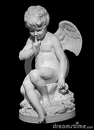 White angel figurine isolated on black background. Cupid sculpture. Stone statue of young cherub Stock Photo