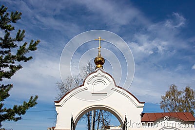 White arch with a dome and cross, entrance to the temple territory Stock Photo