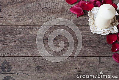 White aromatic vanilla candle and red rose petals. Wooden background. Aromatherapy concept. Romantic background. Rose frame Stock Photo