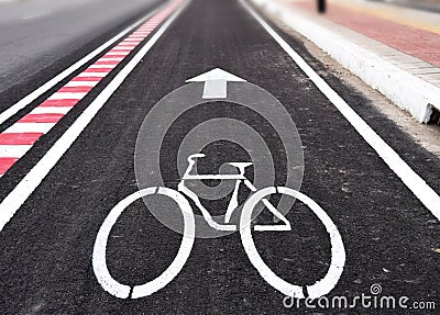 White arrow and bycicle sign on lanes road Stock Photo