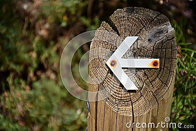 White arrow put into a log Stock Photo